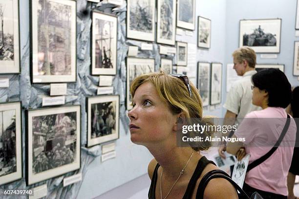 Visitors to the War Remnants Museum reflect on the moving exhibition of Vietnam War photographs, including the devastating effects of napalm attacks,...