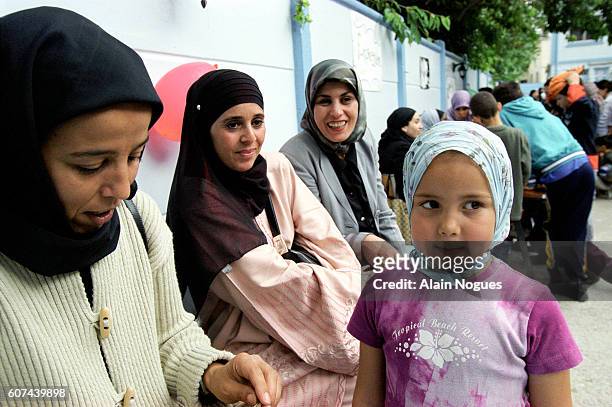 Young girl wearing a veil during the school fete organized by the L.F.F.M .