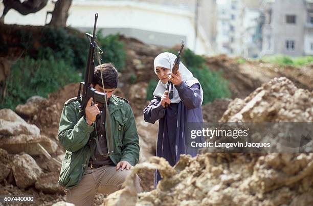 Man and a woman from the Amal movement, a Shiite organization in Lebanon, patrol the Chiah district of Beirut. In 1975, Lebanon fell into a violent...