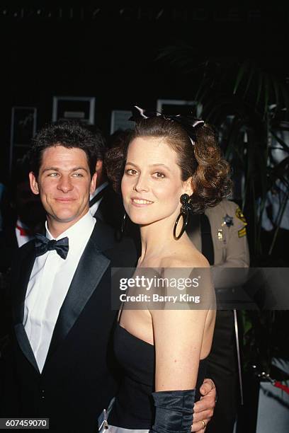 American actress Sigourney Weaver and her husband, stage and film director Jim Simpson attend the 59th Academy Awards ceremony, in Los Angeles.