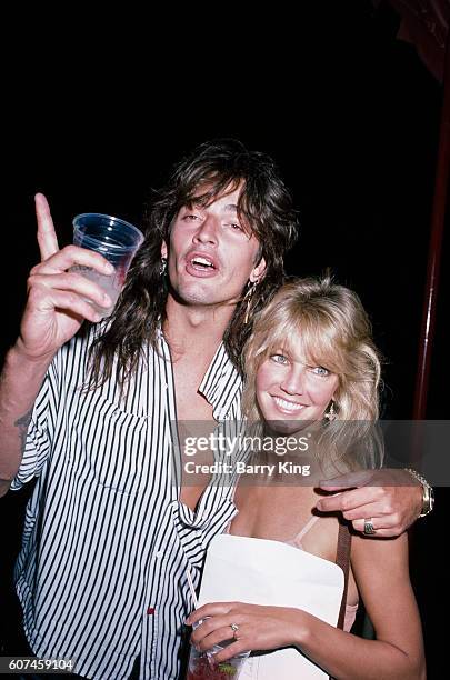 American drummer of glam metal band Motley Crue, Tommy Lee, and his wife, actress Heather Locklear during the concert of British punk rock singer...