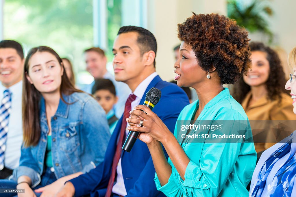 Concerned constituent asks politician a question during meeting