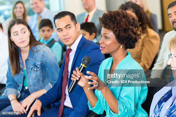 confident african american woman asks question during a meeting - politics imagens e fotografias de stock