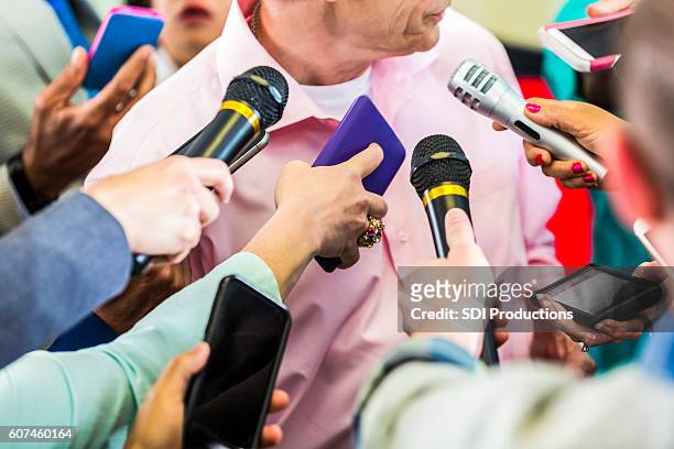 a group of reporters interview political candidate - reporter microphone stock pictures, royalty-free photos & images