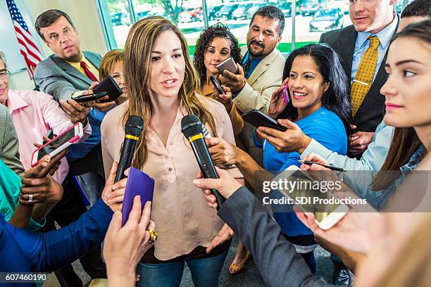 mid adult hispanic female politician answers questions after her speech - microphone press conference stock pictures, royalty-free photos & images