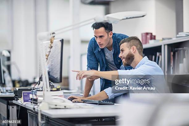 industrial designers at the office discussing project on the computer - innovation creativity stock pictures, royalty-free photos & images