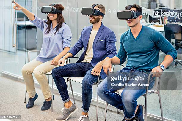 business people on a meeting using  vr headset at office - virtual reality simulator presentation stockfoto's en -beelden