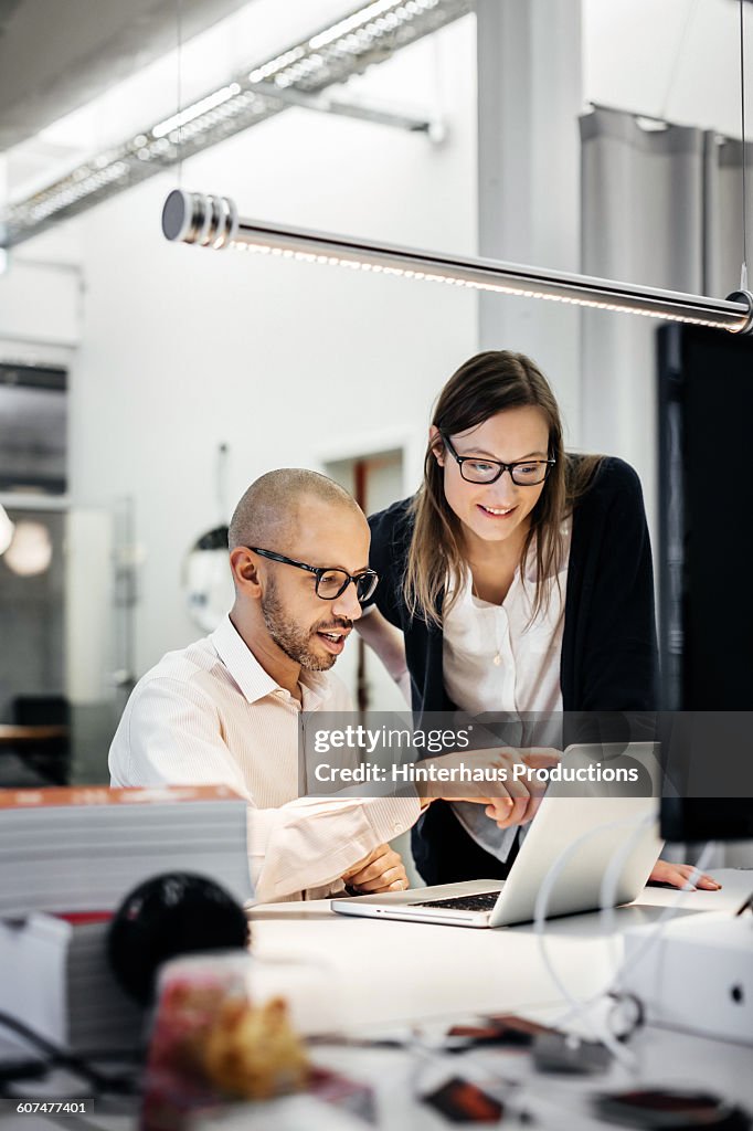 Colleagues working late in modern office