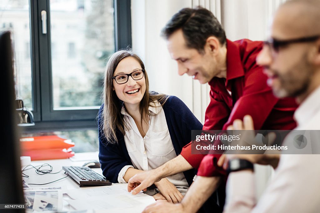 Businesswoman smiling at colleague in office