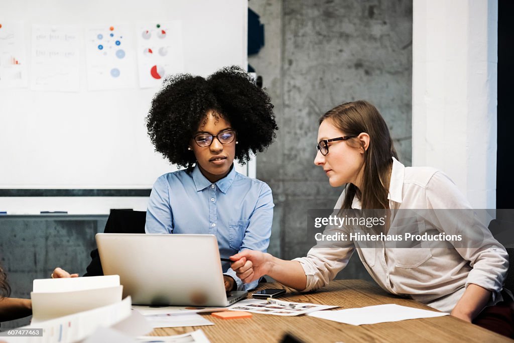 Two young women having a discussion in a business