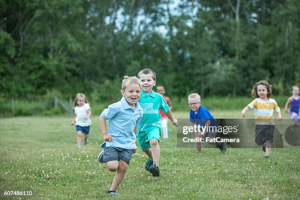 playing tag at the park - skolgård bildbanksfoton och bilder