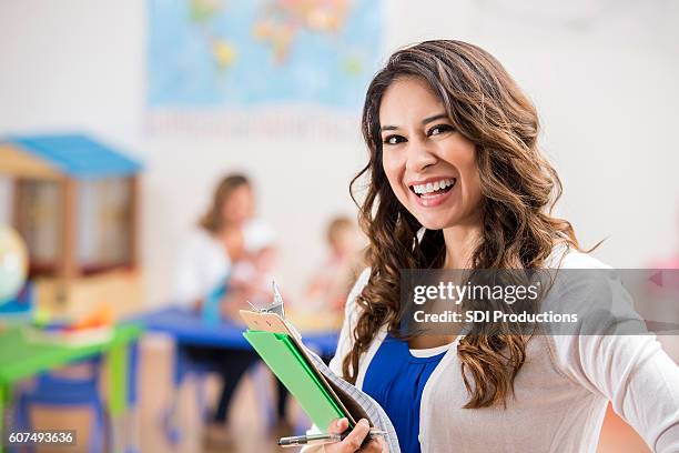 confident hispanic preschool teacher in class - teacher pre school imagens e fotografias de stock