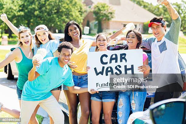 carefree teenagers organize charity car wash - car wash stock pictures, royalty-free photos & images