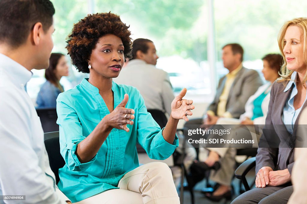 Serious African American woman makes a point during meeting