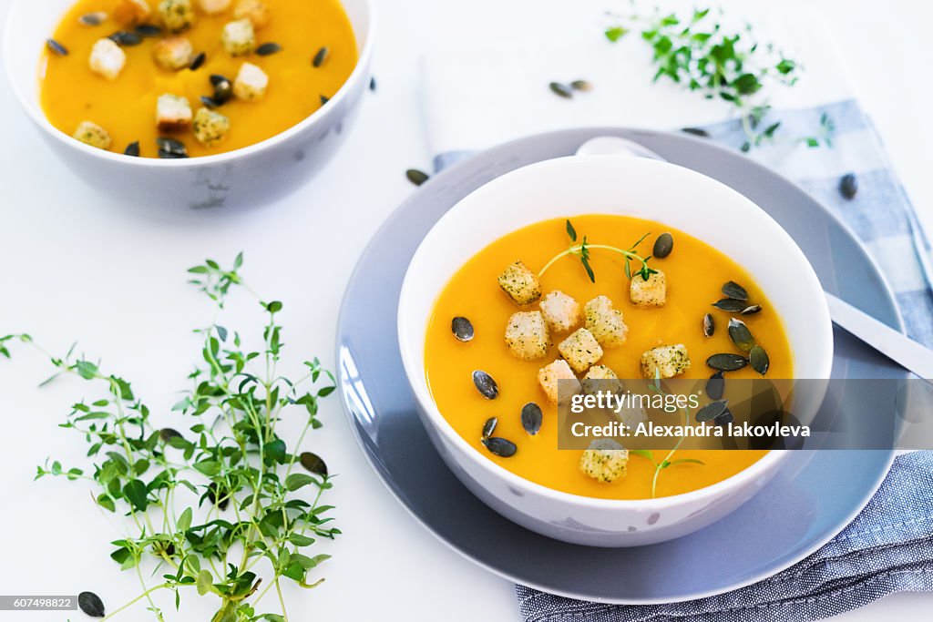 Pumpkin soup served with croutons and pumpkin seeds
