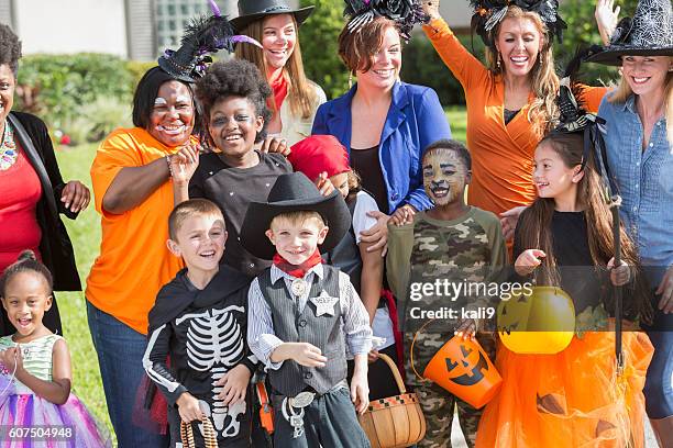 group of women with children in halloween costumes - princess pirates stock pictures, royalty-free photos & images