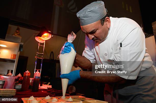 Chef dispenses meringue during the Las Vegas Food & Wine Festival at the SLS Las Vegas Hotel on September 17, 2016 in Las Vegas, Nevada.