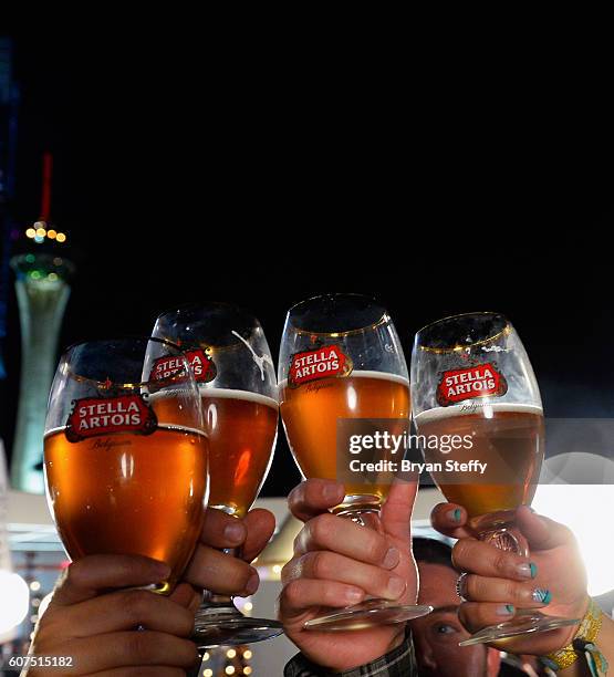 Guests toast with Stealla Artois challis's during the Las Vegas Food & Wine Festival at the SLS Las Vegas Hotel on September 17, 2016 in Las Vegas,...