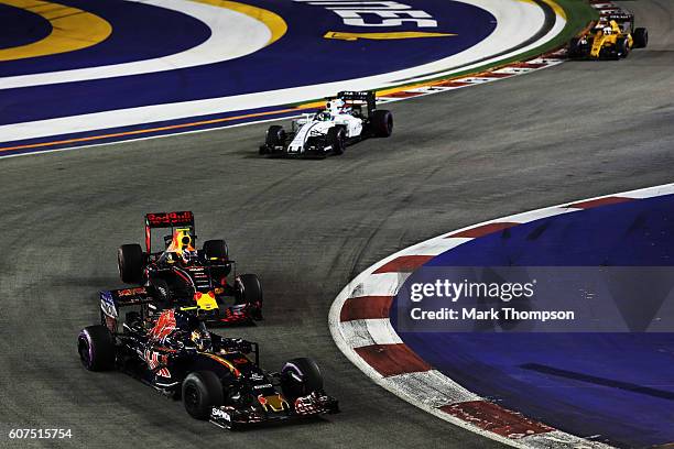 Carlos Sainz of Spain driving the Scuderia Toro Rosso STR11 Ferrari 060/5 turbo leads Max Verstappen of the Netherlands driving the Red Bull Racing...