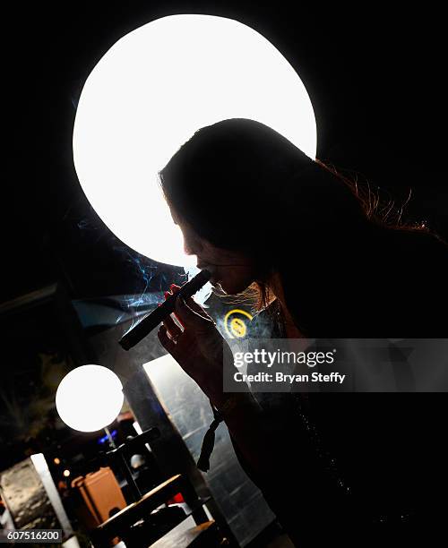 Angelica Lopez of Las Vegas, Nevada smokes a fresh hand rolled cigar from M Cigars during the Las Vegas Food & Wine Festival at the SLS Las Vegas...