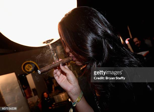 Angelica Lopez of Las Vegas, Nevada smokes a fresh hand rolled cigar from M Cigars during the Las Vegas Food & Wine Festival at the SLS Las Vegas...