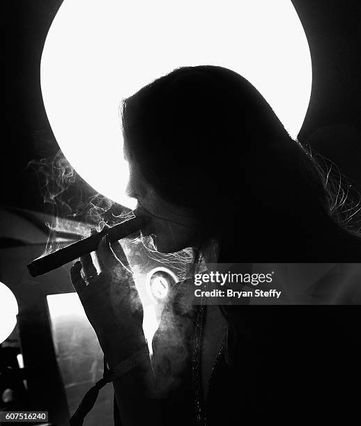 Angelica Lopez of Las Vegas, Nevada smokes a fresh hand rolled cigar from M Cigars during the Las Vegas Food & Wine Festival at the SLS Las Vegas...