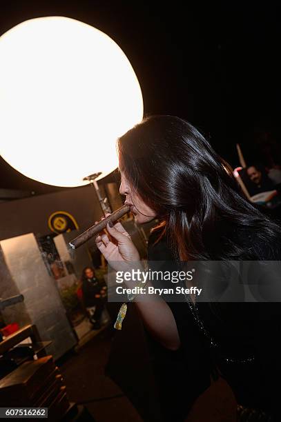 Angelica Lopez of Las Vegas, Nevada smokes a fresh hand rolled cigar from M Cigars during the Las Vegas Food & Wine Festival at the SLS Las Vegas...