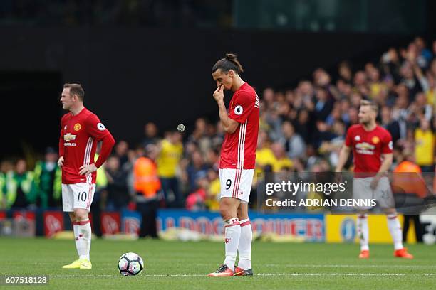 Manchester United's Swedish striker Zlatan Ibrahimovic waits to re-start the match after Watford scored their second goal during the English Premier...