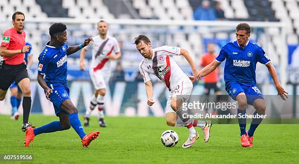 Boubacar Barry of Karlsruhe and Grischa Proemel of Karlsruhe challenges Christopher Buchtmann of St. Pauli during the Second Bundesliga match between...
