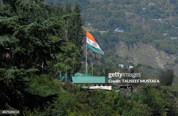 The Indian national flag flies inside a brigade headquarters during a gunbattle between Indian army soldiers and rebels near the border with...