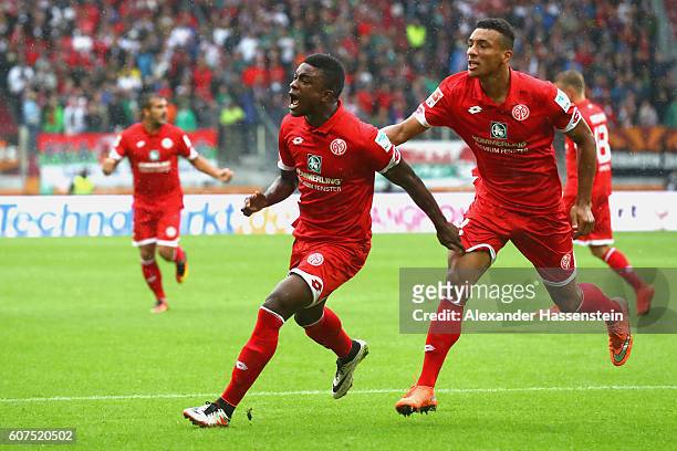 Jhon Andrés Córdoba Copete of Mainz celebrates scoring the opening goal with his team mate Karim Onisiwo during the Bundesliga match between FC...