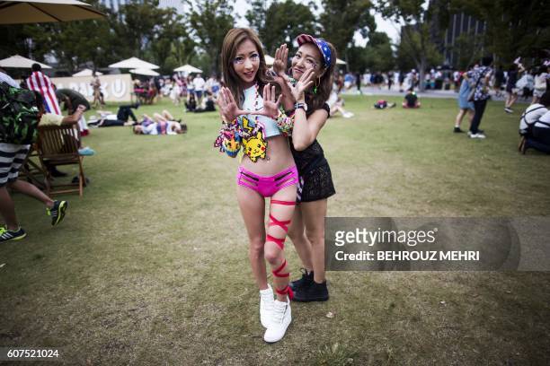 Japanese women pose for a picture as they attend the Japan Ultra Music Festival at Odaiba Ultra Park in Tokyo on September 18, 2016.