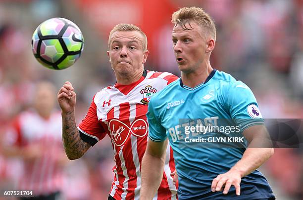 Southampton's Dutch midfielder Jordy Clasie vies with Swansea City's Scottish defender Stephen Kingsley during the English Premier League football...