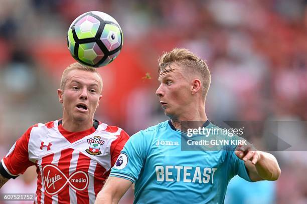 Southampton's Dutch midfielder Jordy Clasie vies with Swansea City's Scottish defender Stephen Kingsley during the English Premier League football...