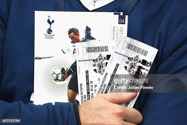 Tottenham Hotspur fan holds his tickets and a match day program during the Premier League match between Tottenham Hotspur and Sunderland at White...