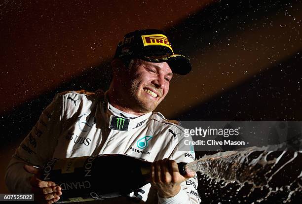 Nico Rosberg of Germany and Mercedes GP celebrates on the podium during the Formula One Grand Prix of Singapore at Marina Bay Street Circuit on...