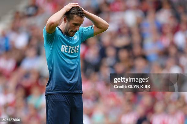 Swansea City's Icelandic midfielder Gylfi Sigurdsson reacts after missing a shot on goal during the English Premier League football match between...