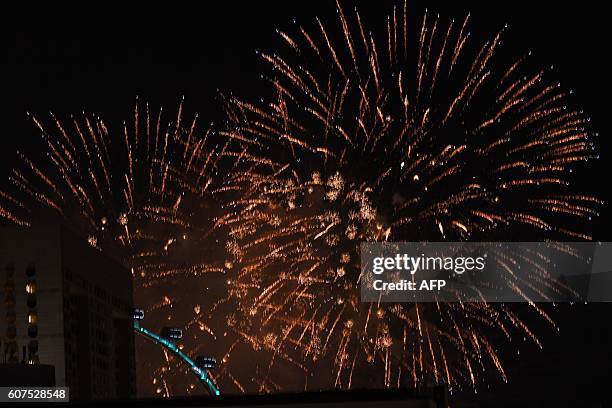 Fireworks light up the sky upon the completion of the Formula One Singapore Grand Prix on September 19,2016. / AFP / Danial Hakim