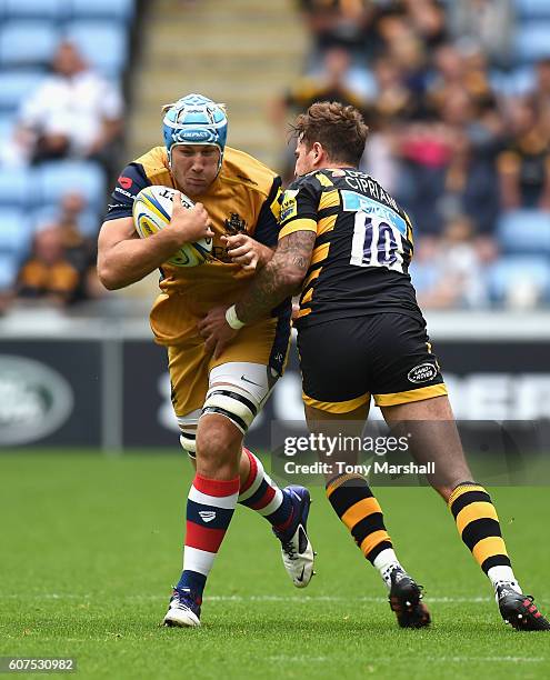 Danny Cipriani of Wasps is tackle Jordan Crane of Bristol Rugby during the Aviva Premiership match between Wasps and Bristol Rugby at The Ricoh Arena...