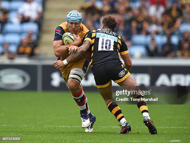 Danny Cipriani of Wasps is tackle Jordan Crane of Bristol Rugby during the Aviva Premiership match between Wasps and Bristol Rugby at The Ricoh Arena...