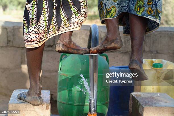 africa, burkina faso, view of women pumping water (year 2007) - borehole stock-fotos und bilder