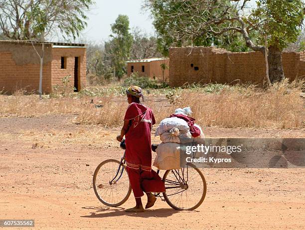 africa, burkina faso, view of women with bicycle (year 2007) - traditional native american medicine stock pictures, royalty-free photos & images
