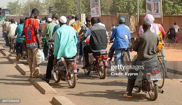 africa, burkina faso, view of people riding mopeds (year 2007) - traditional native american medicine stock pictures, royalty-free photos & images