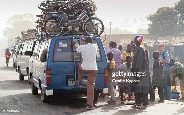 Africa Burkina Faso View Of Overloaded African Taxi With People Sitting On  Roof High-Res Stock Photo - Getty Images