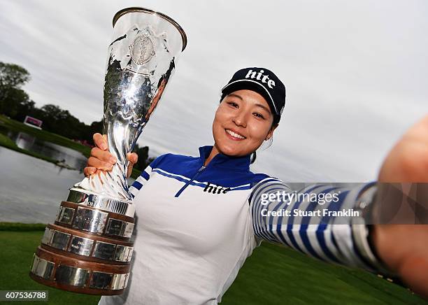 In Gee Chun of Korea imitates a selfie as she poses with the trophy after winning The Evian Championship on September 18, 2016 in Evian-les-Bains,...