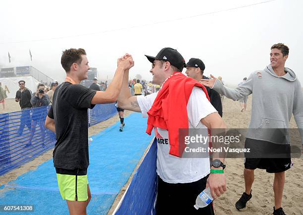 Dylan Efron is congratulated by his borther Zach Efron and olympic gold medalist Conor Dwyer after participating in the Nautica Malibu Traithalon...