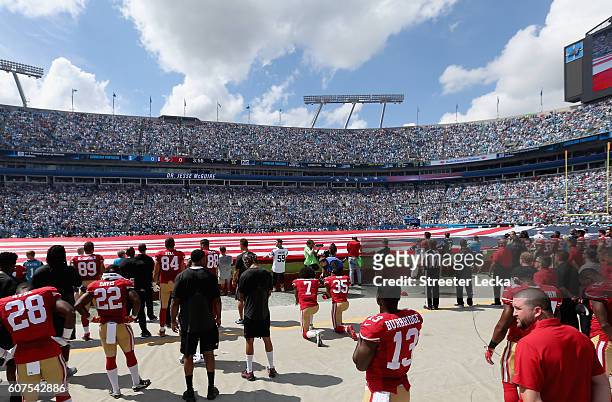 Colin Kaepernick and teammate Eric Reid of the San Francisco 49ers kneel during the national anthem before their game against the Carolina Panthers...