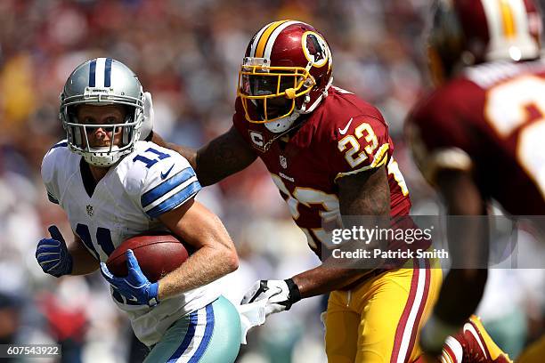 Wide receiver Cole Beasley of the Dallas Cowboys is tackled by free safety DeAngelo Hall of the Washington Redskins in the first quarter at...