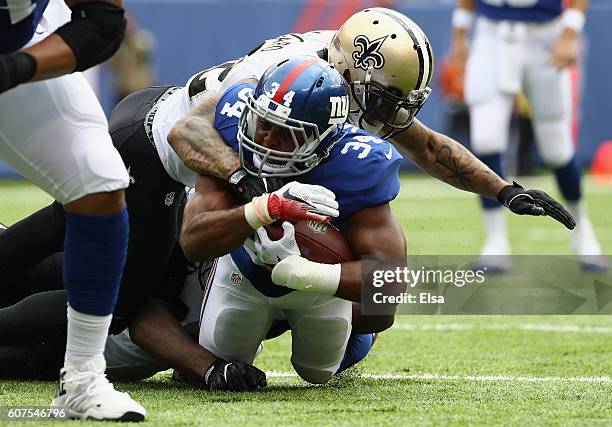 Kenny Vaccaro of the New Orleans Saints tackles Shane Vereen of the New York Giants during the first quarter at MetLife Stadium on September 18, 2016...