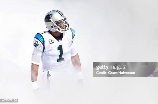 Cam Newton of the Carolina Panthers emerges from the smoke before their game against the San Francisco 49ers at Bank of America Stadium on September...